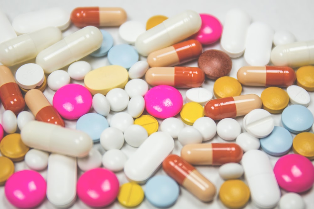 Multiple prescription bottles grouped together on a table for medication review